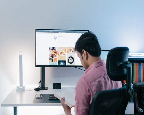 Close-up of a person maintaining a good distance while reading structured data on a modern workspace setup