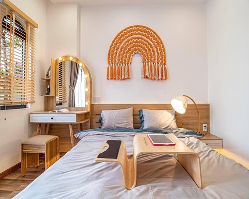 A laptop glowing gently on a dark cozy bedroom table illuminating the surroundings softly